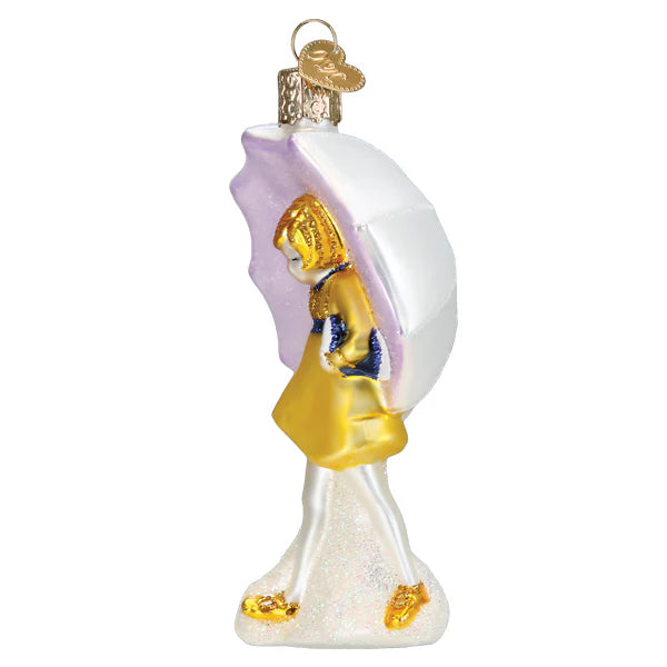 The Morton Umbrella Girl Ornament Old World Christmas 10247 features a girl in a yellow dress with a white and purple umbrella on a glittery white base, complete with a gold hanging loop—perfect for festive decor.