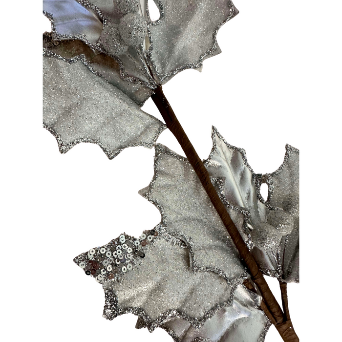 Close-up of the 27 Silver Metallic and Sugared Holly Leaves and Berries Spray 32232, showcasing decorative silver leaves with textured surfaces, glittery edges, and holly leaves for natural elegance.