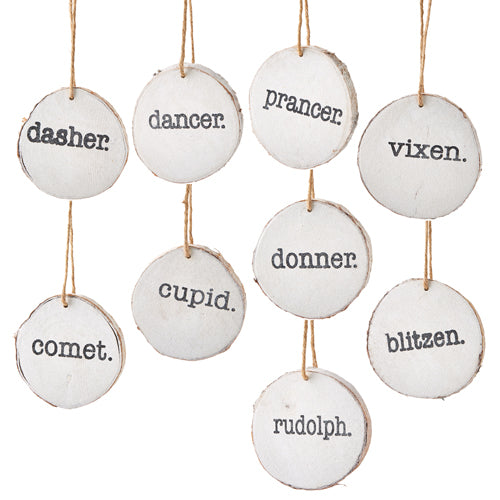 The 4" Santa's Reindeer Disc Ornament 4109889 set includes nine wood slice ornaments, each labeled with a reindeer's name—ideal for adding a festive Santa touch to your Christmas tree.
