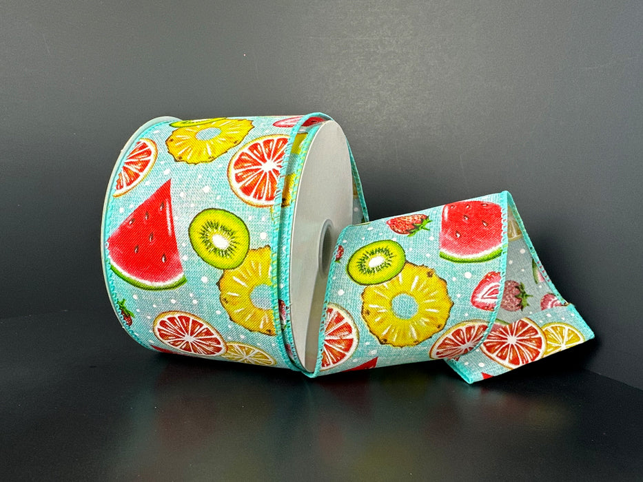 The 2.5X10Y Aqua Satin Fruit Collage White Dots Ribbon 41527-40-45 showcases a lively fruit collage of watermelon, citrus slices, pineapple, and kiwi on a light blue background with white polka dots.