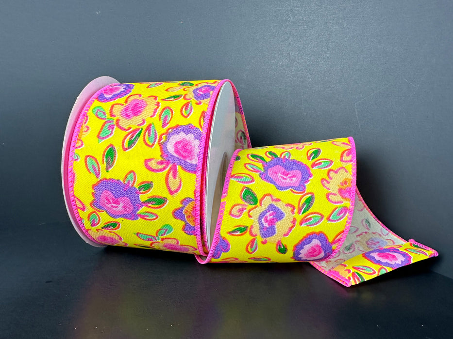 The 2.5X10Y Yellow Satin/Neon Funky Flowers Ribbon (41547-40-22) features a vibrant floral pattern with pink, purple, and blue blossoms accented by green leaves on a yellow ribbon, exuding playful charm against a dark backdrop.