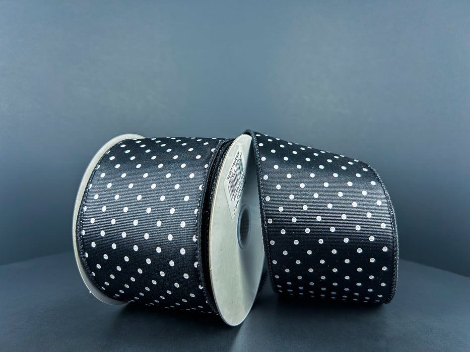 Two rolls of 2.5X10Y Black Ribbed Satin/White Microdots Ribbon 42419-40-21 are set against a gray background, angled slightly towards each other, exuding a shiny, textured elegance.