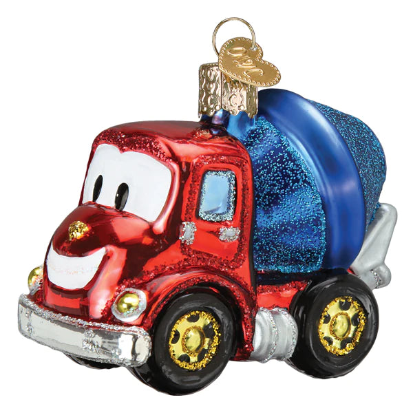 The Cheerful Cement Truck Old World Christmas Ornament 44218 is a hand-painted glass ornament shaped like a smiling red cement truck with a blue drum, gold wheels, cartoon eyes, headlights, and a gold hanging loop.