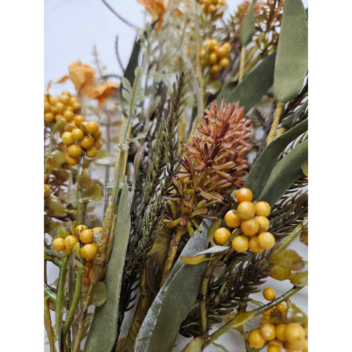 Close-up of the 24 Yellow Lavender Berry Spray 63048-YEL bouquet, featuring dried flowers and foliage. It showcases yellow berry clusters, green and brown leaves, a central reddish-brown spiky blossom, with earthy autumn tones enhanced by touches of yellow lavender spray.
