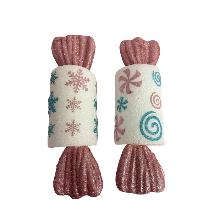 The 13 Candy Set of Two 64257 features pink, blue, and white decorative candy-shaped items with glittery ends and festive snowflake and peppermint designs on a white background.