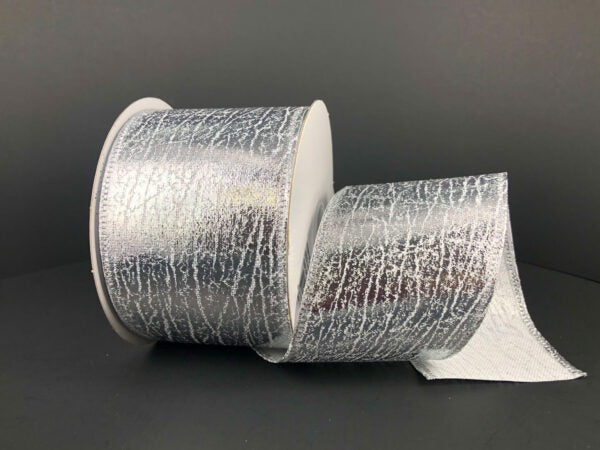 A partially unrolled spool of 2.5X10Y Silver Crackle Lame Ribbon (75206-40-16) with a wide, metallic silver, crackle-textured design is displayed against a plain dark background.