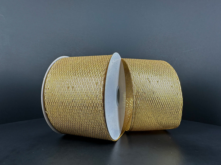 Two spools of 2.5X10Y Gold Stairstep Woven Metallic 76310-40-15 ribbon sit side by side against a dark background, their metallic surfaces showcasing detailed textured patterns.