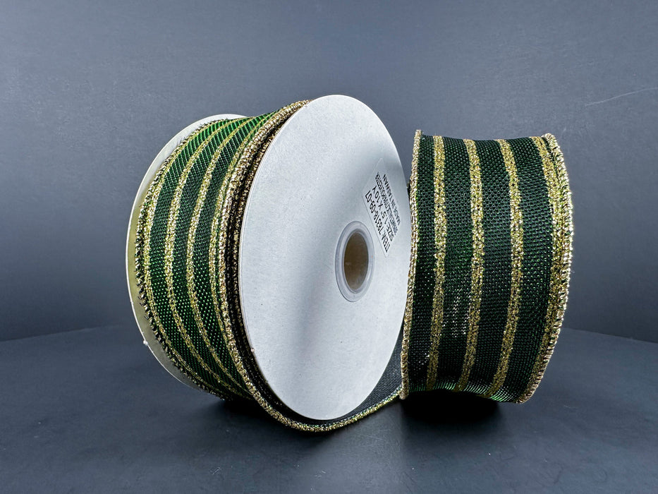 Two spools of 1.5" x 10-yard dark green metallic and gold glitter vertical stripes ribbon, upright on a dark background. The ribbons are coiled around white cylindrical cores, with one glittering ribbon slightly covering the other.