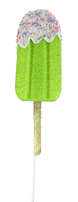 A whimsical Glittery, green popsicle ornament named "21-inch-by-4-inch-by-1.5-inch Green Sprinkle Popsicle Spray 86105GN," features a sparkly stick and is finished with white frosting adorned with colorful sprinkles, perfect for adding charm to any decor on a black background.