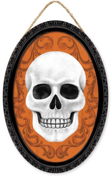 The 13Hx9L Framed Skull Oval Sign (AP729720) features a white skull on an orange background with ornate scrollwork, set in a black frame and hanging by twine. Black/White/Orange color scheme.