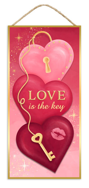 The 12.5 H x 6 Pink/Burgundy/Gold/White MDF Love Is The Key Sign (AP7360) features three stacked heart shapes with gold keyholes, a gold key, LOVE is the key on the center heart, and a lipstick kiss on the bottom heart.