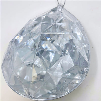 The 6.3" x 4" x 9" Silver Plastic Drop Ornament (DCORN5408SL) features a faceted, teardrop design with a top loop for hanging, reflecting light beautifully with its geometric surfaces.