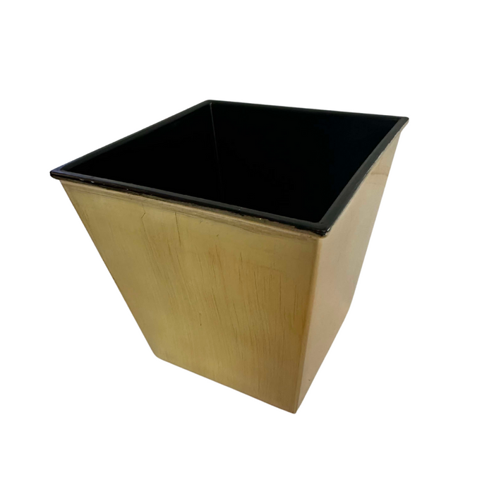 The 5 Christmas Gold Square Plastic Pot P0220XGLD features a gold exterior and black interior. Its elegant design, with a wider top and narrower base, makes it perfect for adding luxury to any space against the white background.