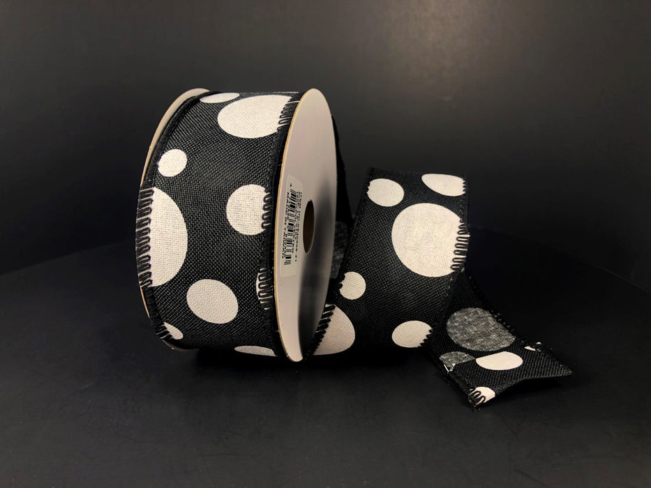 A spool of Black Linen/White Big-Small Dots ribbon, 1.5X10Y, artfully unrolled against a dark background.