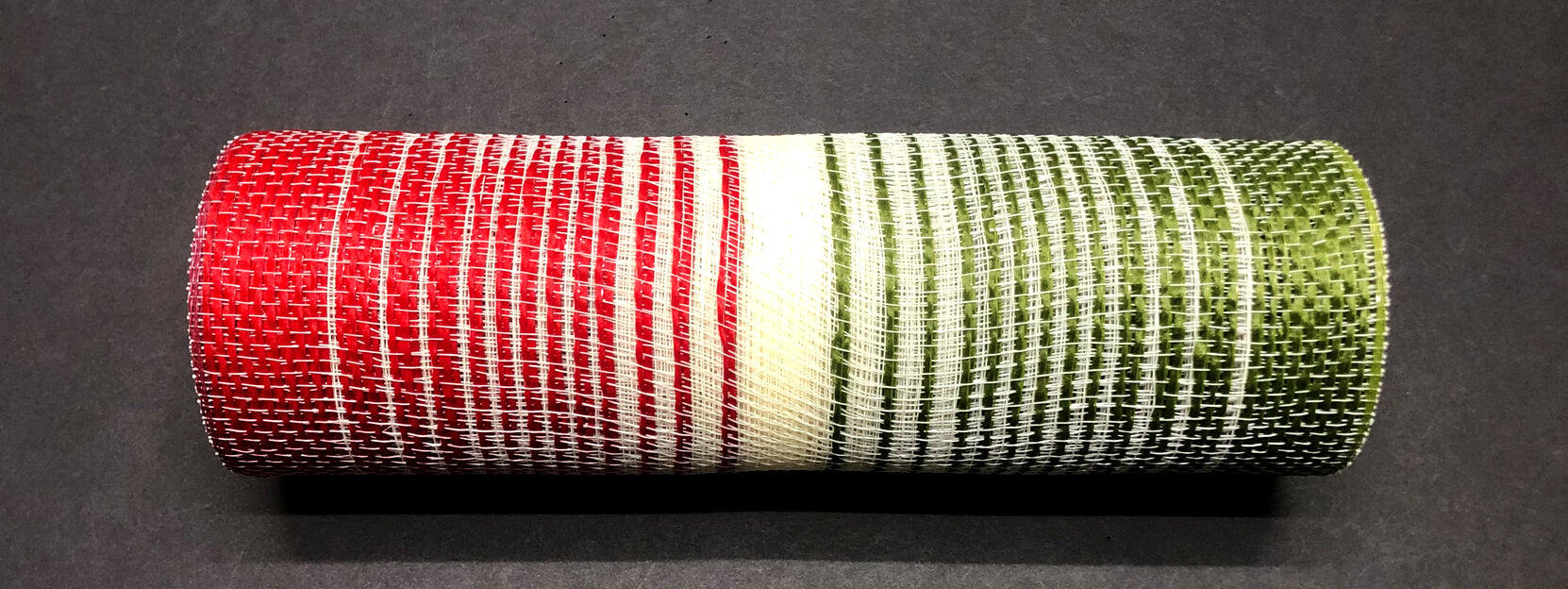 The 10X10Y Red-Cream-Moss Jute Ombre Mesh (XB108310-08) lies horizontally on a dark surface, showcasing its distinct segmented colors and woven texture.