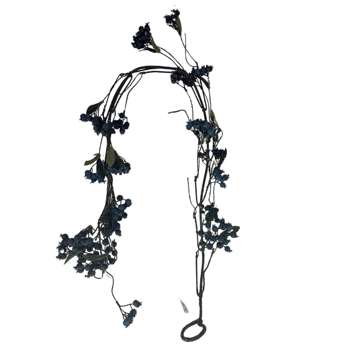 The 49 Blue Berry Garland (item #61135) features delicate dark florals with small blue flowers, green leaves, and intertwined blue berries. Its arranged in an arc with a loop at one end, set against a plain white background.