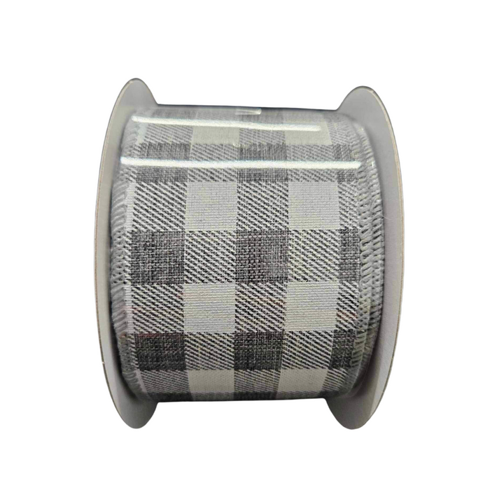 Meet the 2.5X10Y Grey White Check Ribbon C2340-078, featuring a striking black, gray, and white checkered pattern with large alternating squares on a spool. Its intricate design is perfect for any creative project!.