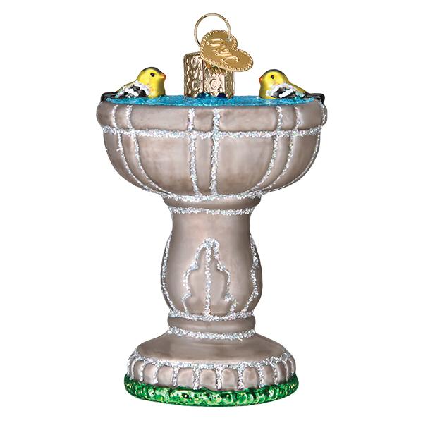 The Birdbath Old World Christmas Ornament 16131 is a hand-painted glass ornament shaped like a stone birdbath, featuring two yellow birds, blue water, and a gold hanging loop on top.
