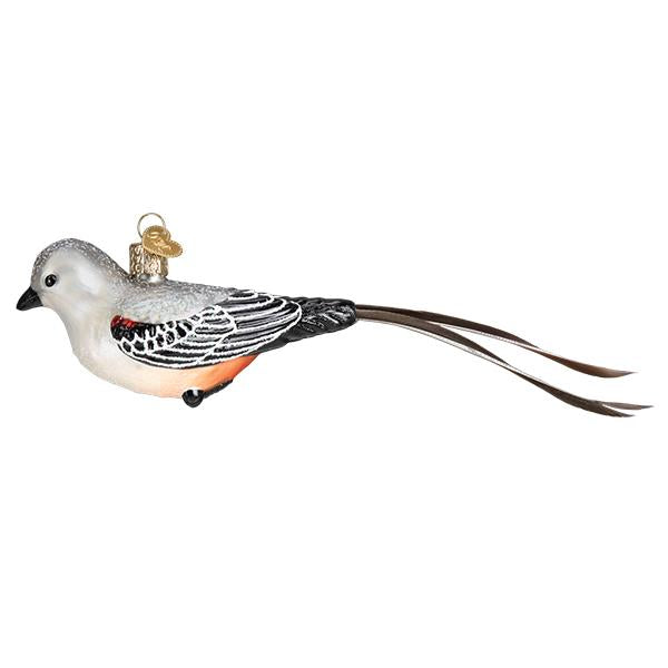 The Scissor Tailed Flycatcher Bird Old World Christmas Ornament 16132 is a mouth-blown glass ornament featuring a white head, black and gray wings, orange belly, long tail feathers, and a metal loop for hanging.