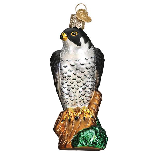 The Peregrine Falcon Ornament by Old World Christmas features a black head, silver-spotted body, and brown talons on a leafy branch. Complete with a gold hanging loop, this ornament adds elegance to your holiday décor.