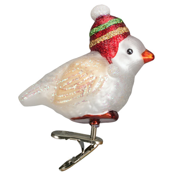 The Red Hat Snowbird Ornament by Old World Christmas (18141) features glittery wings, an orange beak, and a striped red, green, and gold winter hat with white pom-poms—attached to a metal clip for classic charm.