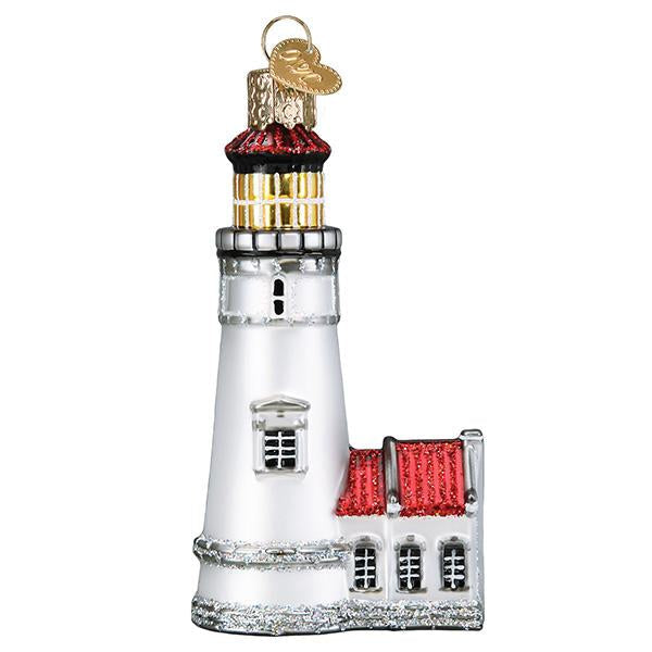 The Heceta Head Lighthouse Old World Christmas Ornament 20122 is a glass decoration featuring a white tower, red roof, gold accents, and a gold hanging loop, inspired by Oregon’s iconic lighthouse.