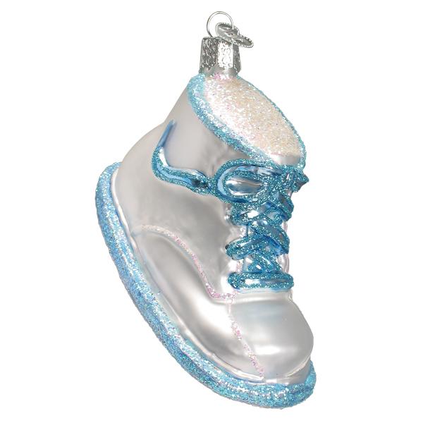 The Blue Baby Shoe Ornament (Old World Christmas 32491) is a charming sneaker-shaped keepsake with a shiny silver body, glittery blue laces and trim, and a silver loop for tree hanging, perfect for commemorating that memorable first step.