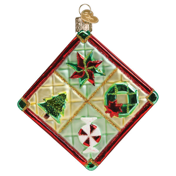 The Christmas Quilt Ornament (Old World Christmas 32550) features a diamond shape with red edges, poinsettia, wreath, tree, and peppermint candy on a gold and green checkered background in classic Old World style.