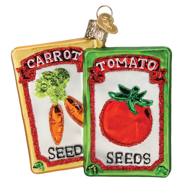 The Garden Seeds Ornament by Old World Christmas (36312) includes two glittery glass ornaments shaped like seed packets—one Carrot Seeds and one Tomato Seeds—with hanging loops, perfect for gardeners or seed packet displays.