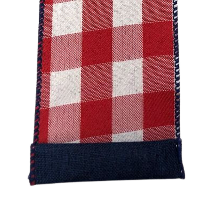 Close-up of the 2.5 Two-Sided Red White Buffalo Plaid Navy Back Ribbon 41146-40-74 detailing its woven texture and visible stitching resembling a decorative hem finish.