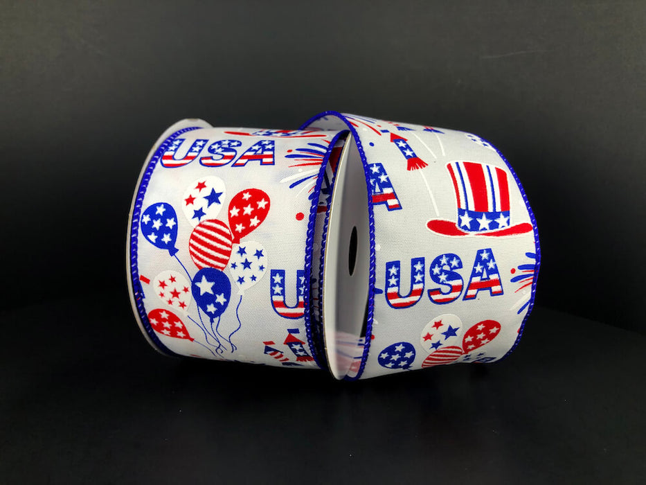 The USA Celebration Ribbon, product 41321-40-01, is 2.5 x 10Y of wired satin featuring USA, stars, stripes, balloons, and top hats in red, white, and blue on a dark background for structured decor.