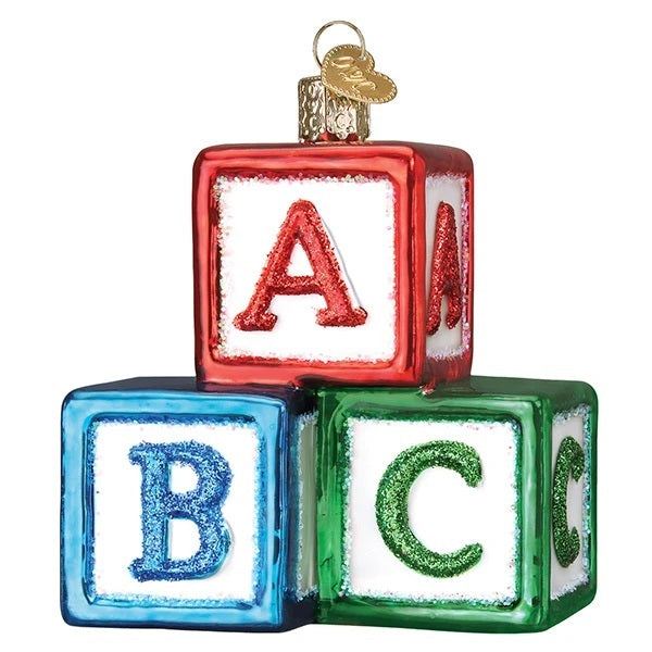 The Abc Blocks Old World Christmas Ornament 44161 features three hand-painted glass blocks (A-red, B-blue, C-green) stacked in a glittery pyramid with a shiny festive finish and a gold hanging loop.