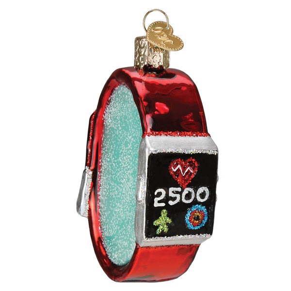 The Fitness Watch Ornament by Old World Christmas (#44182) features a shiny red and silver design with a display showing a heart, 2500, colorful activity icons, and hangs from a gold loop.
