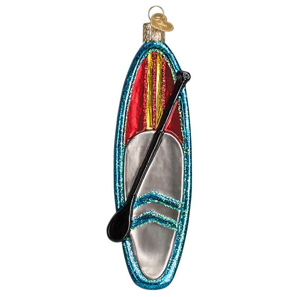 The Blue Stand Up Paddle Board Ornament by Old World Christmas (46103) features a stand-up paddleboard with a paddle, decorated in blue, red, yellow, and silver glitter with a gold hanging loop—perfect surfing decor for your tree.