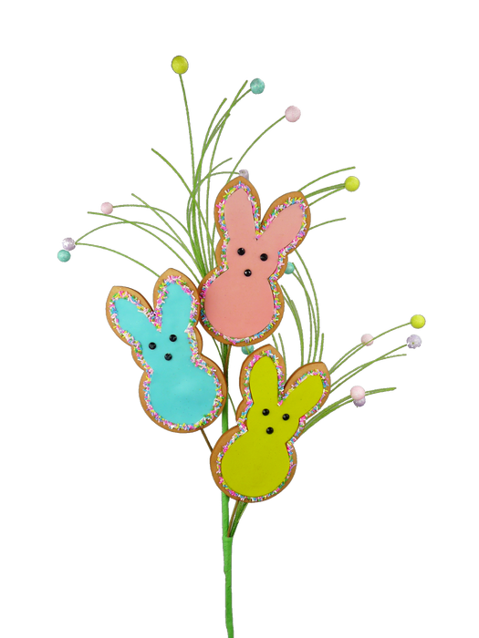 The 27" Bunny Cookie Spray with 3 Stems 62901EAS features an array of colorful, bunny-shaped cookies on long sticks, creating a bouquet-like appearance. These bunnies in soft pastel hues of blue, pink, and yellow with sprinkle-edged details perch atop three stems accented with small pastel balls, adding a festive flair against the gray backdrop.