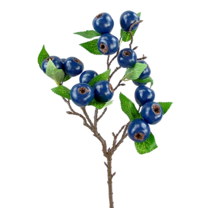 The 23 Blueberry Spray 62945BL showcases an artificial branch with shiny blue berries and green leaves. The realistic berries feature brown stems, and the textured leaves expertly mimic natural foliage, all set against a white background.