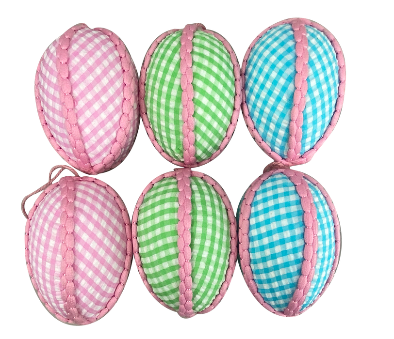 Six 4" fabric gingham egg ornaments from product 62994ASST are displayed in two rows. The top row has two pink and one green gingham-patterned ornaments, while the bottom row features two blue and one green gingham-patterned ornaments, each adorned with pink trim.