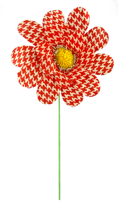The 24 by 8 Orange Houndstooth Sunflower Spray features striking fabric petals with an orange houndstooth pattern and a vibrant yellow textured center, perched on a thin green stem against a black background.