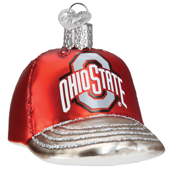 The Ohio State Baseball Cap Ornament (Old World Christmas 64819) is a shiny red and silver glass ornament shaped like a cap, featuring the Ohio State University logo and Ohio State on the front, with a metallic hanging loop.