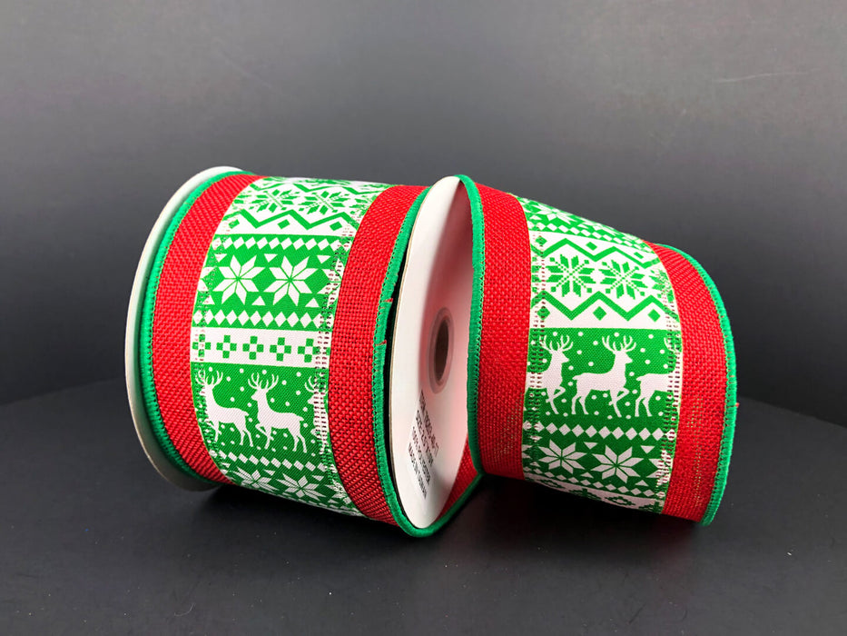 Two spools of the Green-White Christmas Sweater/Red Edge, 2.5X10Y Ribbon (78203-40-17) display a green and white pattern with reindeer, snowflakes, and geometric designs against a dark background, creating a cozy holiday feel.