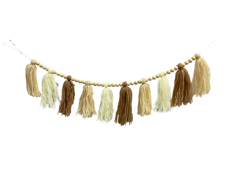 Product 85622CMBN: A 4-foot Cream and Brown Yarn Tassel Bead Garland features alternating beige and brown tassels, strung with small wooden beads, evenly spaced to give a festive rustic look against a black background.