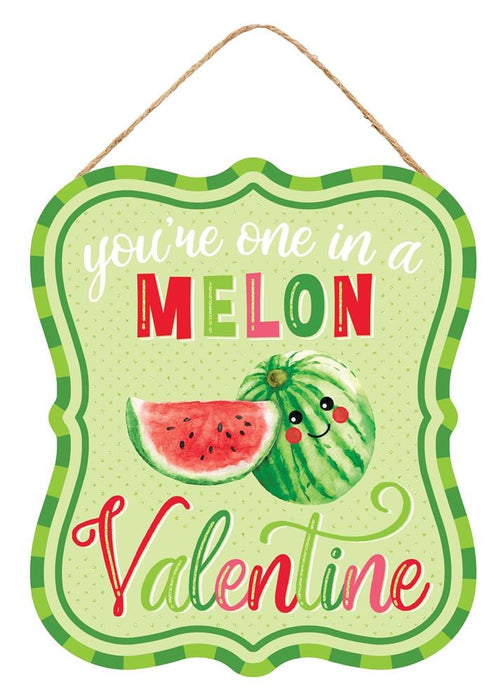 The 10.5Hx9L One In A Melon Valentine sign (AP7832) features a green and white polka dot background with playful text that says Youre one in a melon, Valentine. It includes a cute watermelon illustration with green stripes on durable MDF/Paper for lasting enjoyment.