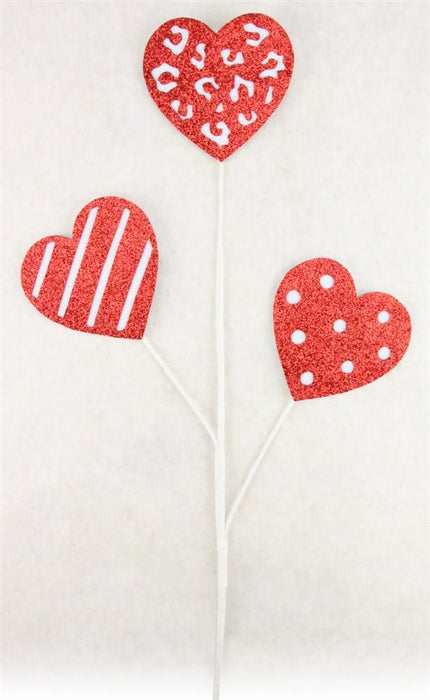 The 25"H Glitter Pattern Hearts Pick X3 in Red/White (HV026024) features three uniquely designed red and white glitter hearts on white sticks, displaying captivating animal print, stripes, and polka dots against a plain white background. Ideal for adding a sparkling touch to any setting.