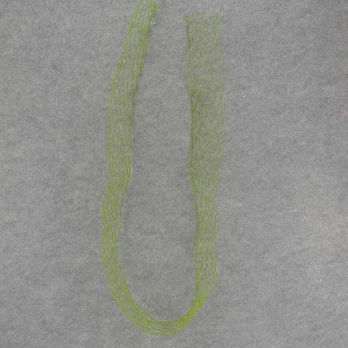 The 6 by 3.75 Wide Ribbon Wire With Moss (SA7057) is shown as a green, flexible mesh tube arranged in an open loop on a plain gray background.