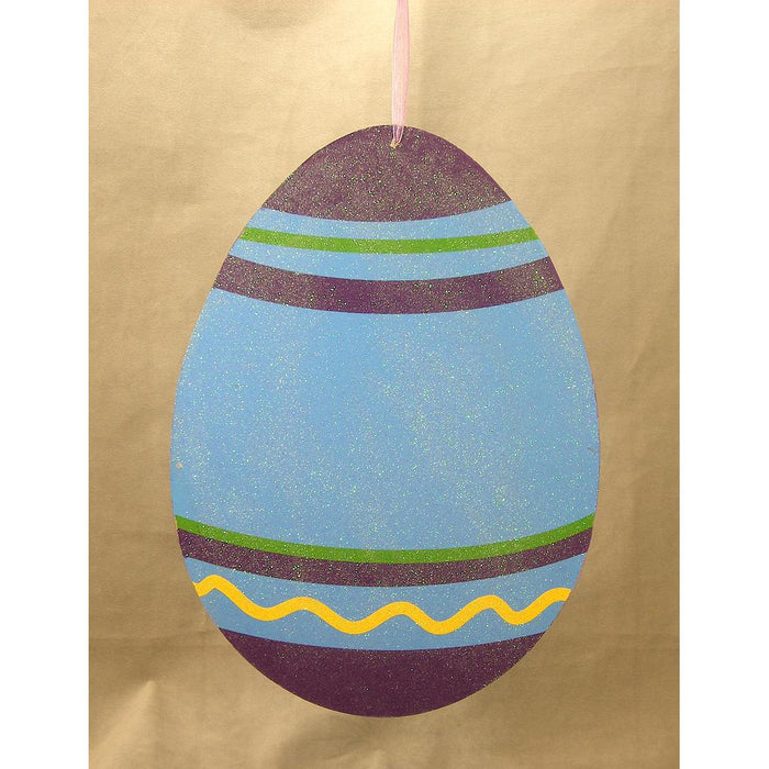 The 11.5 by 8.75 Blue Display Easter Egg (SG312-BLU) features a striking blue base with purple bands, green stripes, and a yellow wavy line, hanging elegantly against a brown background—perfect for your seasonal display.