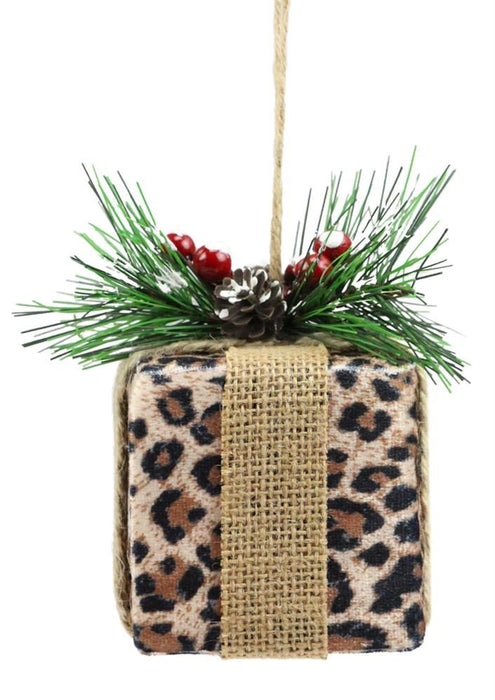 The 4.5H Leopard Print Gift Ornament (Tan/Black/Brown, XJ4345) features burlap ribbon, faux pine needles, red berries, and a small pine cone, all hanging from a rustic twine loop.