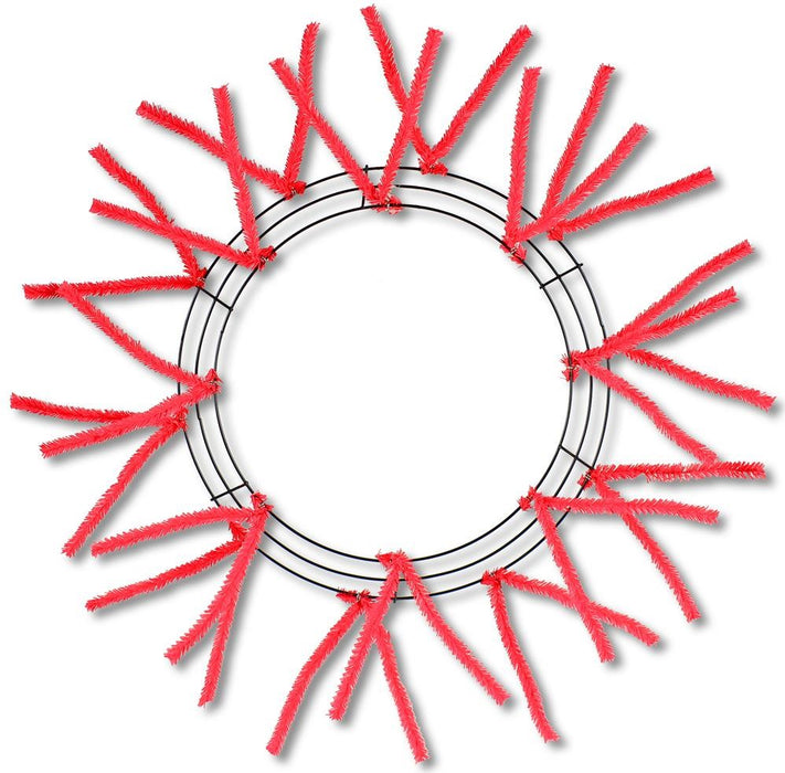 The Pencil Wreath Red Non-Metallic 24 XX750424 includes fluffy red chenille stems attached around the outer edge, fanning outward like rays. The circular frames empty center allows for endless creative wreath designs.