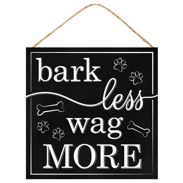The 10 Bark Less Wag More Sign AP7101 features white text, paw prints, and bone designs on a black square background. Hanging by twine, it’s a charming home decor accent ideal for any dog lover.