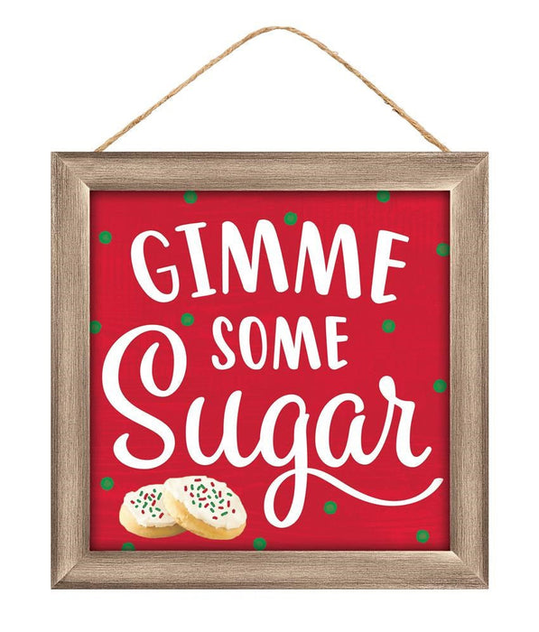 The 10Sq MDF Gimme Some Sugar Sign (AP7168) features a red background with green dots, white GIMME SOME Sugar text, and two decorated sugar cookies at the bottom left. Hangs on a string. Colors: red/white/emerald/light brown.