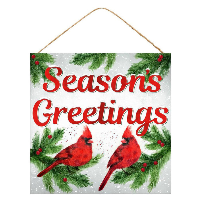 The 10 Seasons Greetings with Cardinal Christmas Sign (AP8550) is a festive MDF decoration with red lettering, green pine branches, red berries, vibrant cardinals on a snowy background, and hangs by a string.